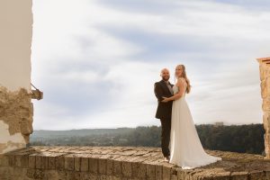 Hochzeitsfotografie Brautpaar auf Mauervorsprung mit Ausblick